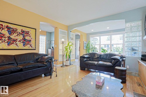 Hardwood flooring, recessed lighting, built-in shelving, glass block accent wall, and archways - 10814 125 Street Nw, Edmonton, AB 