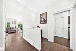 Hardwood flooring throughout, recessed lighting, and white trim accents - 