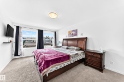 Wall-to-wall carpeting, dual windows with curtains, and a ceiling-mounted light fixture - 