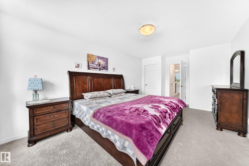 Carpeted flooring extending throughout, white painted walls, and a ceiling-mounted light fixture - 2015 Chalmers Way Sw, Edmonton, AB 