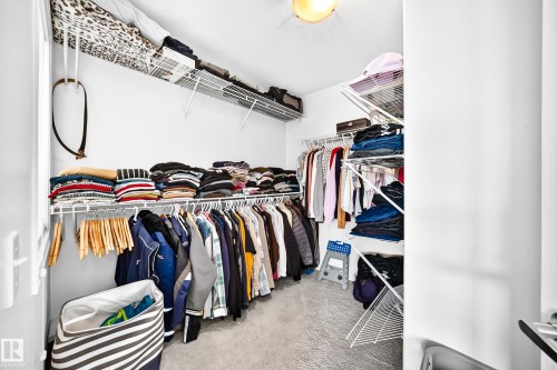Walk-in closet featuring wire shelving and hanging rods - 2015 Chalmers Way Sw, Edmonton, AB 