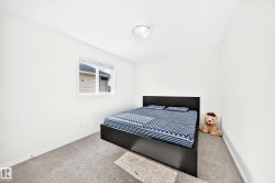Carpeted flooring, white walls, and a single window with blinds - 