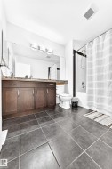 Dark wood-finish vanity with drawer and cabinet storage, stone-look countertop, and integrated sink - 