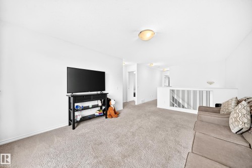 Light-colored carpeting throughout, white wall finishes, and a contemporary railing design - 2015 Chalmers Way Sw, Edmonton, AB 