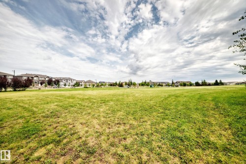 Expansive green space featuring mature trees and a residential backdrop - 2015 Chalmers Way Sw, Edmonton, AB 