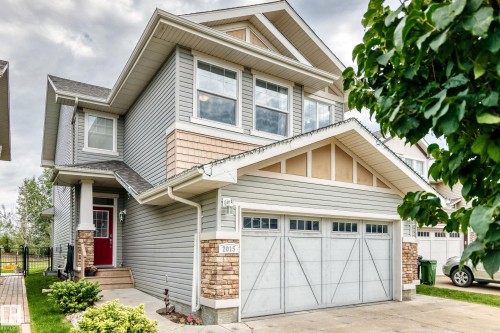 Two-story exterior with horizontal siding and shingle accents - 2015 Chalmers Way Sw, Edmonton, AB 