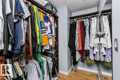 Built-in closet shelving with hanging rods and wood-finish flooring - 18431 95A Avenue Nw, Edmonton, AB 