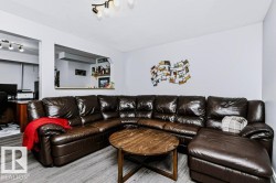 Wood-finish flooring throughout, a pass-through window with a built-in shelf, and track lighting fixtures - 