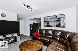 Recessed wall opening with built-in countertop, track lighting fixture, and wood-finish flooring - 