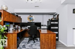 U-shaped built-in wood-finish desk with integrated upper cabinetry - 