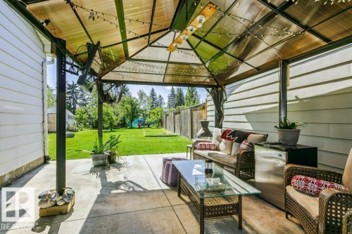 Covered patio with a concrete surface, metal gazebo structure, and a fenced backyard with a manicured lawn - 18431 95A Avenue Nw, Edmonton, AB 