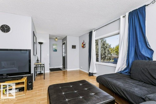 Wood-finish flooring, recessed window, and white textured ceiling - 18431 95A Avenue Nw, Edmonton, AB 