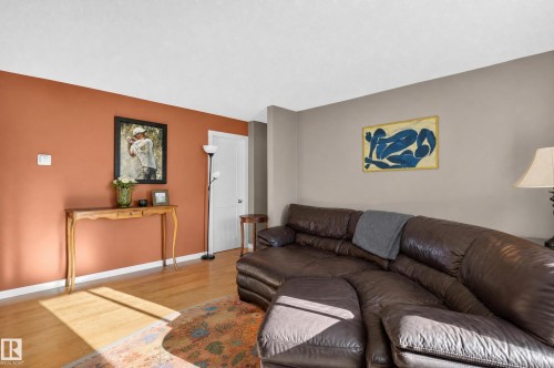 Wood-finish flooring with a contrasting accent wall - #204 7407 171 St Nw, Edmonton, AB 