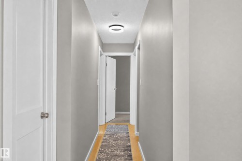 Hardwood-finish flooring, recessed lighting, and crisp white trim - #204 7407 171 St Nw, Edmonton, AB 
