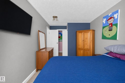 Recessed lighting, textured ceiling, light gray wall paint, and a white interior door - #204 7407 171 St Nw, Edmonton, AB 