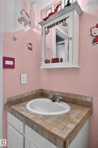White vanity with an integrated sink and mosaic tile countertop - #204 7407 171 St Nw, Edmonton, AB 