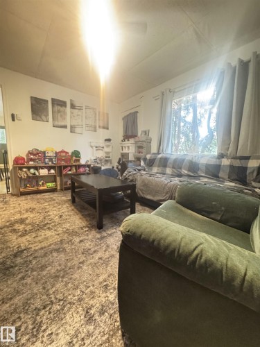 living room features hard wood floor and picture window - 5019 48 Avenue, Onoway, AB - Indoor