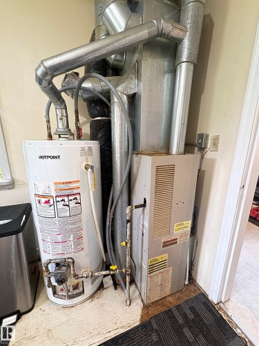 features furnace and hot water tank - 5019 48 Avenue, Onoway, AB - Indoor Photo Showing Basement