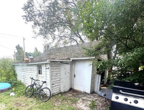 Detached single car Garage with wood-finish siding and a shingled roof - 5019 48 Avenue, Onoway, AB - Outdoor