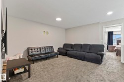 Spacious carpeted room featuring recessed lighting and a neutral color palette - 