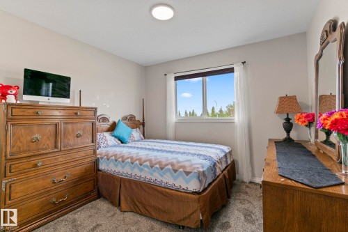 Bright bedroom featuring neutral wall tones and a window with natural light - 2131 51 Sw, Edmonton, AB - Indoor Photo Showing Bedroom