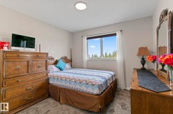 Bright bedroom featuring neutral wall tones and a window with natural light - 