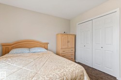 Neutral tone wall paint complements the light brown carpet flooring - 