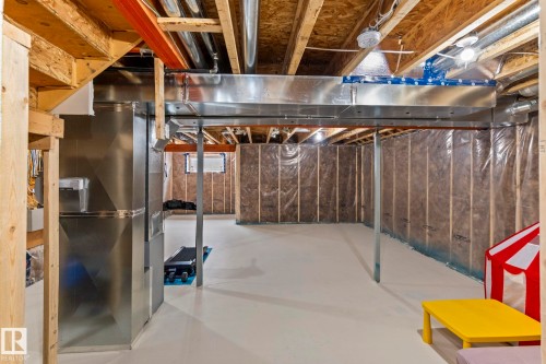 Unfinished basement with exposed ceiling joists, substantial ductwork, and framed, insulated walls - 2131 51 Sw, Edmonton, AB - Indoor Photo Showing Basement