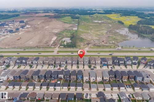 Aerial perspective of a developed residential street with rows of detached homes, featuring dark-toned roofs - 2131 51 Sw, Edmonton, AB - Outdoor With View