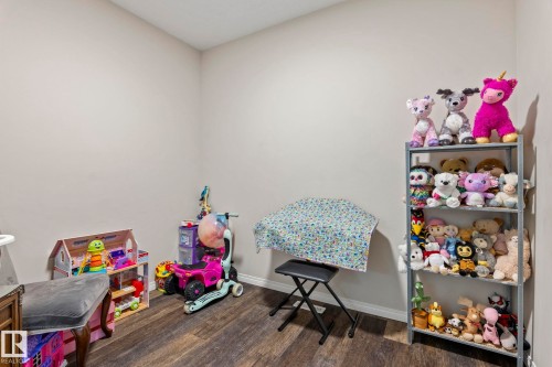 Interior room featuring neutral wall paint and wood-finish flooring - 2131 51 Sw, Edmonton, AB - Indoor Photo Showing Other Room