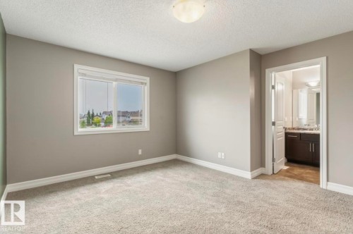 Carpeted room featuring neutral-toned walls, a white trim package, and a double-pane window - 79 Catalina Crest, Fort Saskatchewan, AB - Indoor Photo Showing Other Room