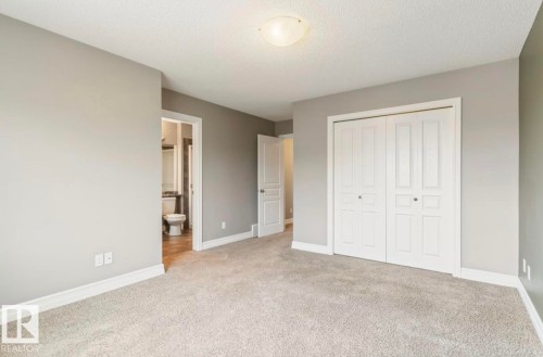 Carpeted room featuring light gray walls, white baseboards, and a semi-flush mount ceiling light - 79 Catalina Crest, Fort Saskatchewan, AB - Indoor