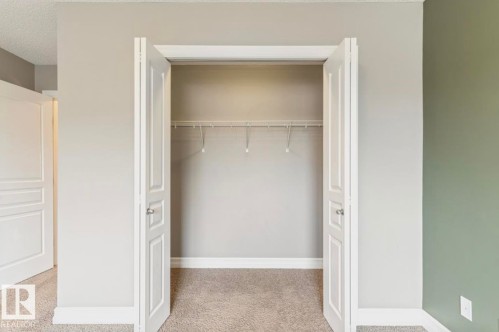Spacious closet with bi-fold panel doors and integrated wire shelving - 79 Catalina Crest, Fort Saskatchewan, AB - Indoor