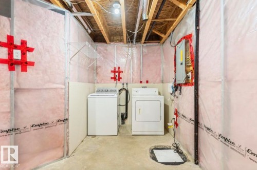 Utility area featuring exposed ceiling joists and unfinished insulation - 79 Catalina Crest, Fort Saskatchewan, AB - Indoor Photo Showing Laundry Room