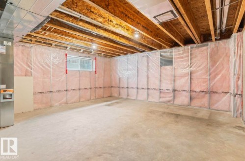 Unfinished basement space with exposed wooden joists, concrete flooring, and insulated walls - 79 Catalina Crest, Fort Saskatchewan, AB - Indoor Photo Showing Basement