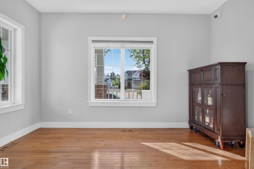 Wood-finish flooring, light gray walls, and white trim - 1251 Summerside Drive Sw, Edmonton, AB 