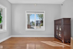 Wood-finish flooring, light gray walls, and white trim - 
