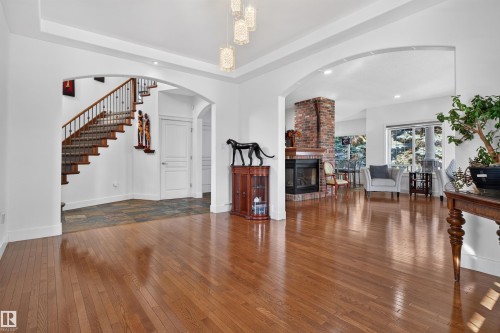 Hardwood flooring extends throughout, complemented by arched entryways - 1251 Summerside Drive Sw, Edmonton, AB 