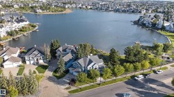 Lakefront properties featuring multiple homes with private docks and mature landscaping - 