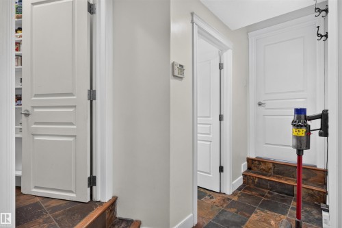 Staircase with tile flooring and wood-finish risers - 1251 Summerside Drive Sw, Edmonton, AB 