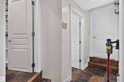 Staircase with tile flooring and wood-finish risers - 