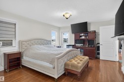 Hardwood flooring, light wall finishes, built-in desk cabinetry, and a ceiling-mounted light fixture - 