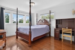 Hardwood flooring, recessed lighting, and multiple windows with white trim - 