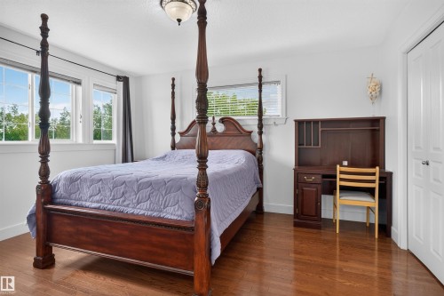Hardwood flooring, recessed windows, built-in shelving, white paneled doors, and a ceiling-mounted light fixture - 1251 Summerside Drive Sw, Edmonton, AB 