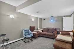 Recessed ceiling, neutral wall paint, wall-mounted sconces, and built-in speakers - 