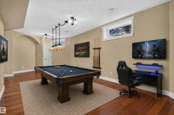 Hardwood flooring, recessed lighting, arched entryway, window with white trim, built-in desk with integrated lighting - 