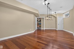 Expansive room featuring wood-finish flooring, recessed lighting, and a pendant light fixture - 