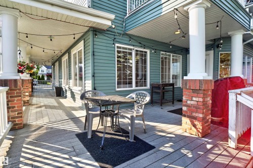 Expansive deck featuring a wood-finish floor and white railings - 1251 Summerside Drive Sw, Edmonton, AB 