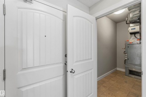 utility room with storage space & laundry - #111 4922 52 St, Gibbons, AB 