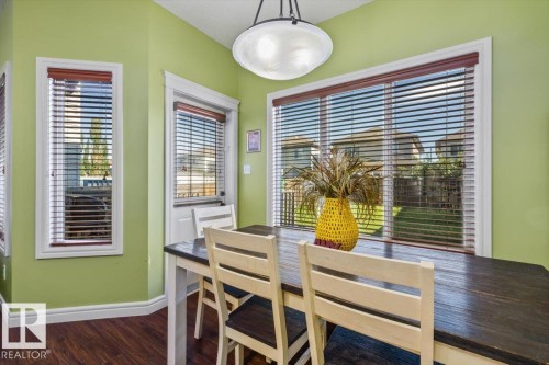 Wood-finish flooring with white trim and a ceiling-mounted light fixture - 11506 17 Avenue Sw, Edmonton, AB 